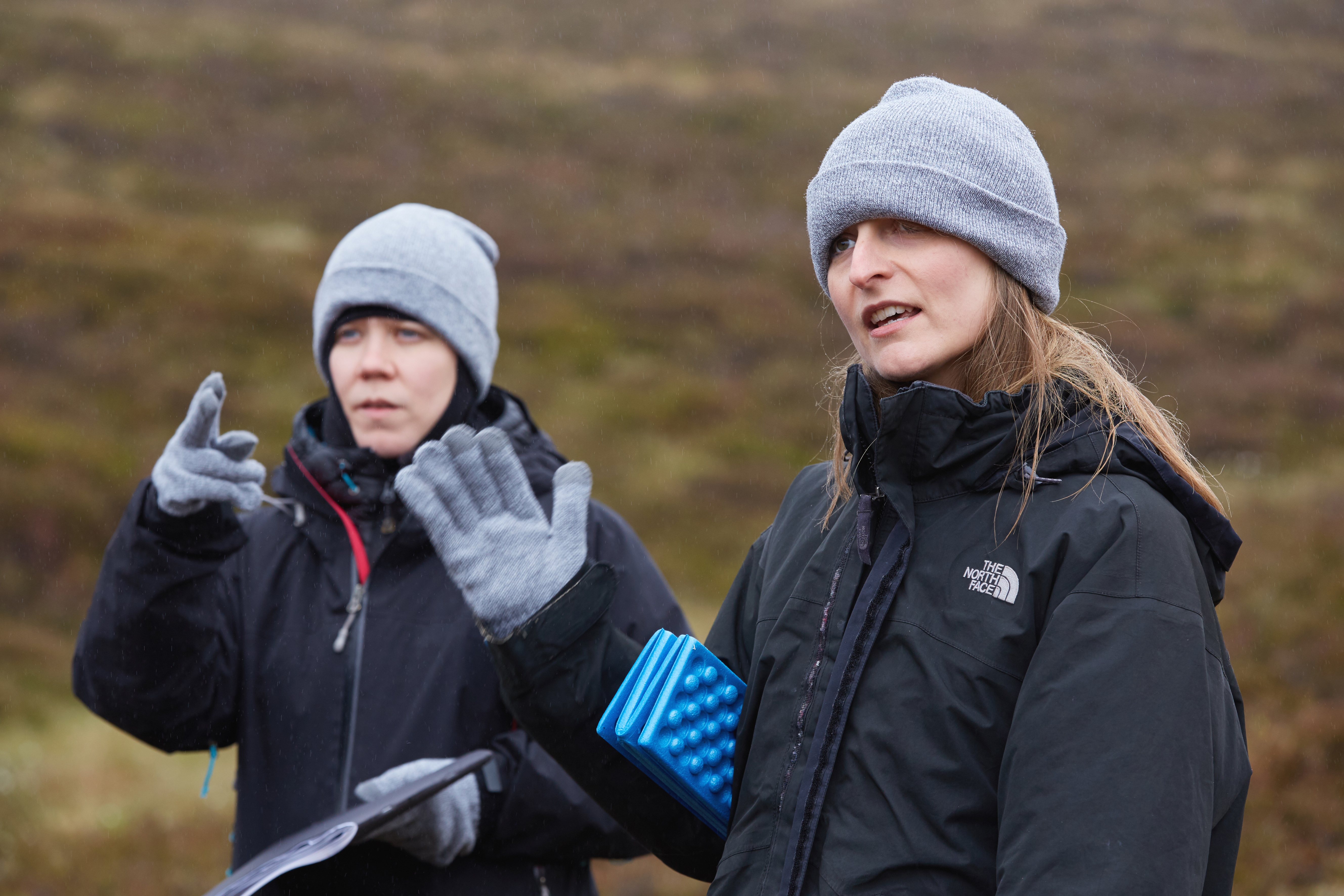 Choir leader conducts a group in song